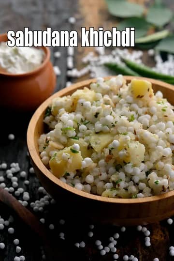 A wooden bowl of Sabudana Khichdi garnished with fresh coriander and peanuts, served with a side of curd.