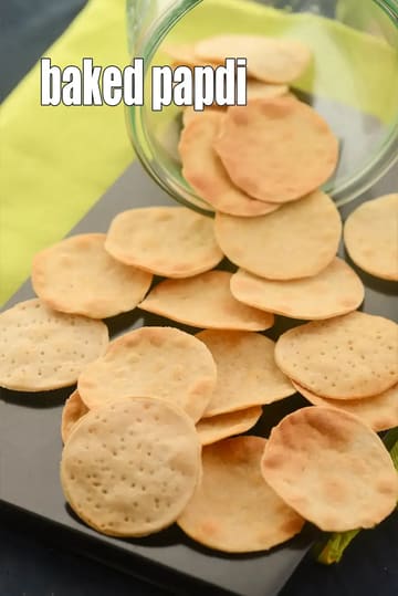 Baked papdi snacks served on a plate, showing round, crispy papdi biscuits with a light golden color, prepared as a healthy baked Indian snack.