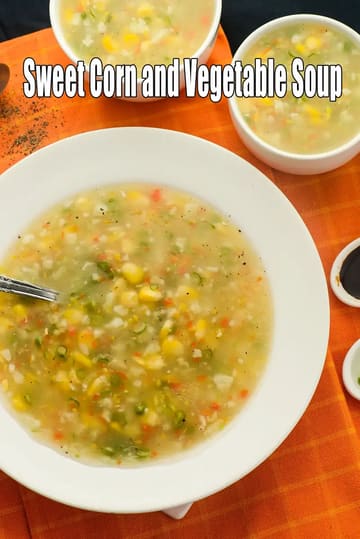 Sweet Corn and Vegetable Soup in a large white bowl filled with a clear, hearty vegetable soup containing yellow sweet corn kernels, chopped carrots, and green onions.
