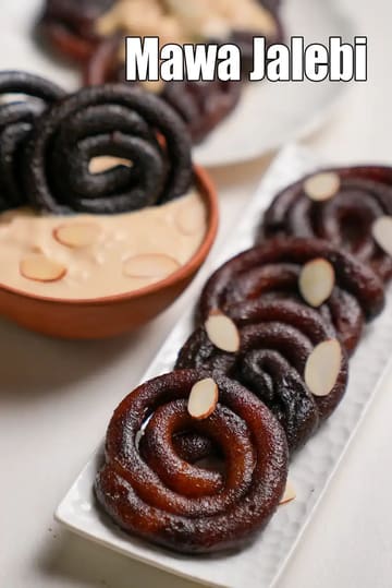Mawa jalebi arranged on a white rectangular plate, dark brown spiral-shaped jalebis garnished with almond slices, served with a bowl of creamy rabri in the background.