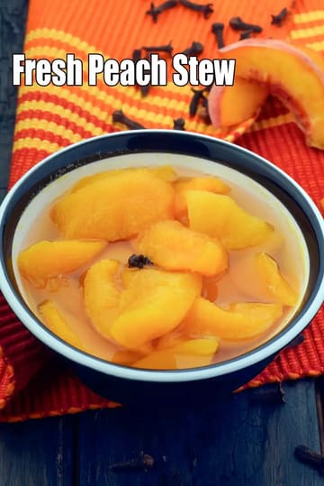 A bowl of fresh peach stew with soft peach slices soaked in light syrup, garnished with cloves, placed on an orange patterned cloth, with peach wedges and whole cloves visible in the background and the text “Fresh Peach Stew” on the image.