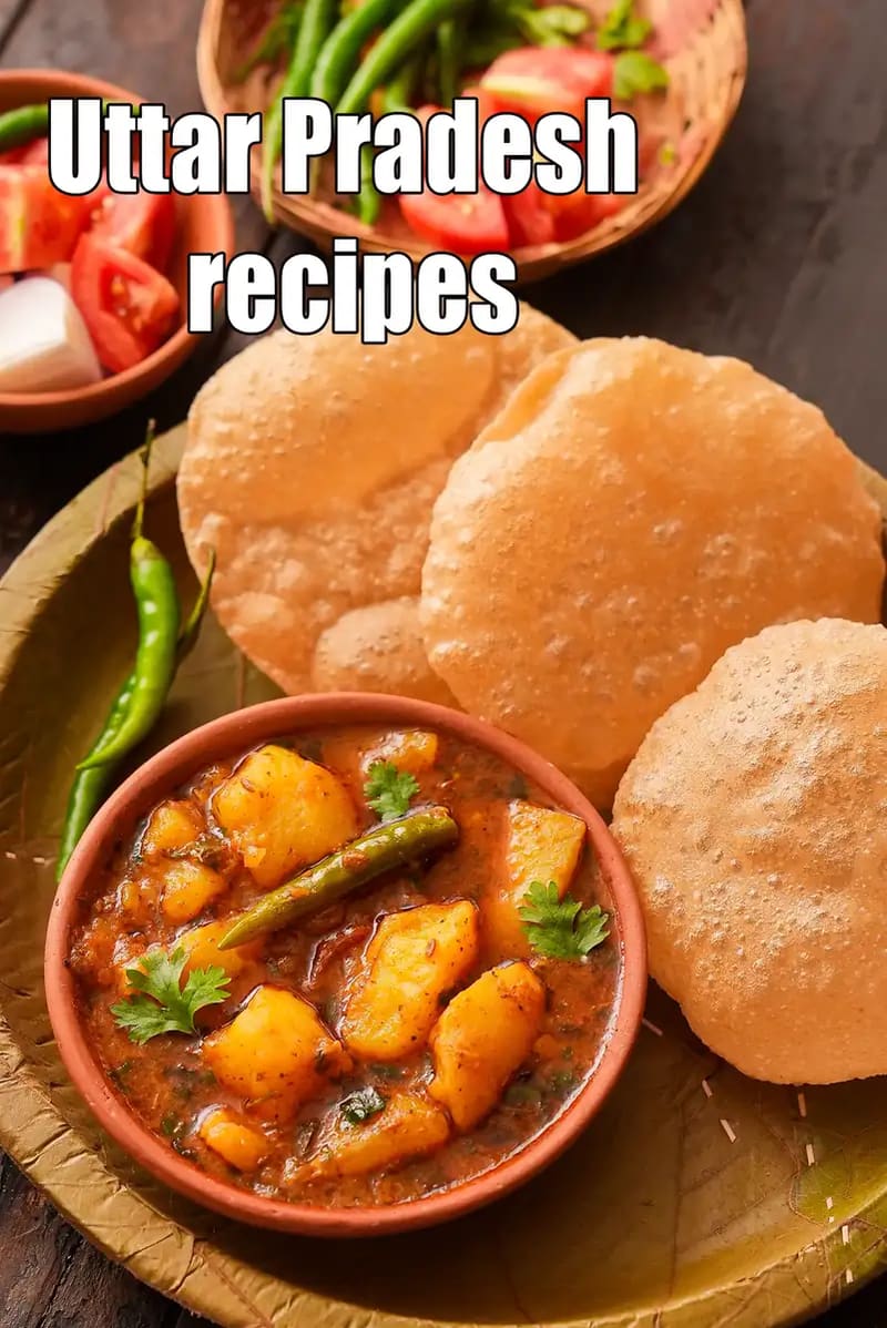 Aloo Poori, a traditional Uttar Pradesh recipe featuring puffed pooris served with spicy potato curry garnished with green chillies and coriander.