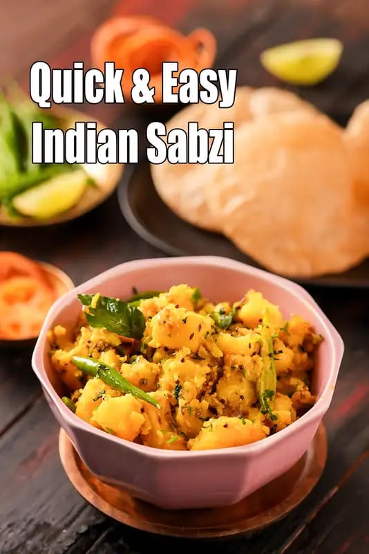 A bowl of aloo sabzi with roti on the side.