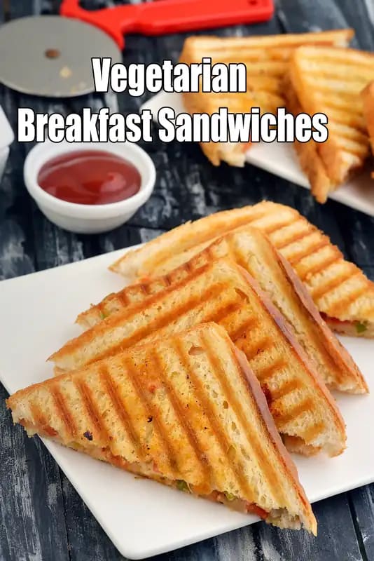 sandwiches made with triangle bread slices, veggie filling, and lettuce garnish, served with ketchup and mayo dips.