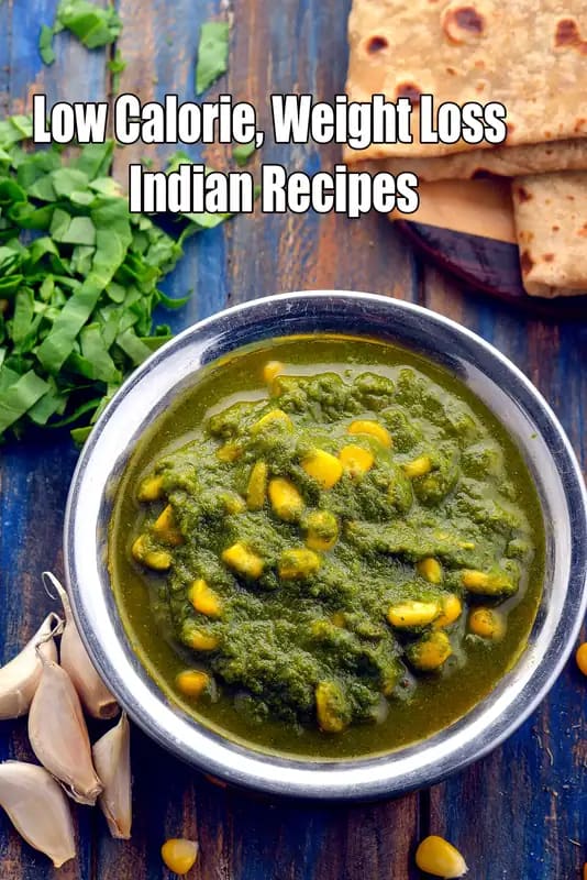 Low calorie Indian palak corn curry served in a steel bowl with roti, spinach leaves and garlic on a rustic wooden background