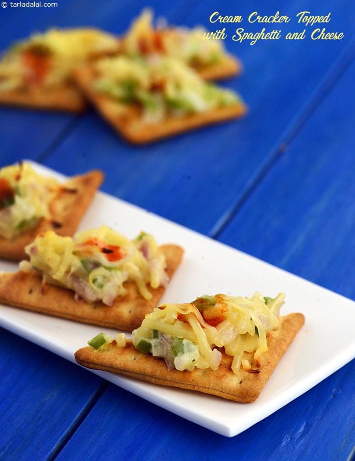 Cream Cracker Topped with Spaghetti and Cheese | Tarla Dalal