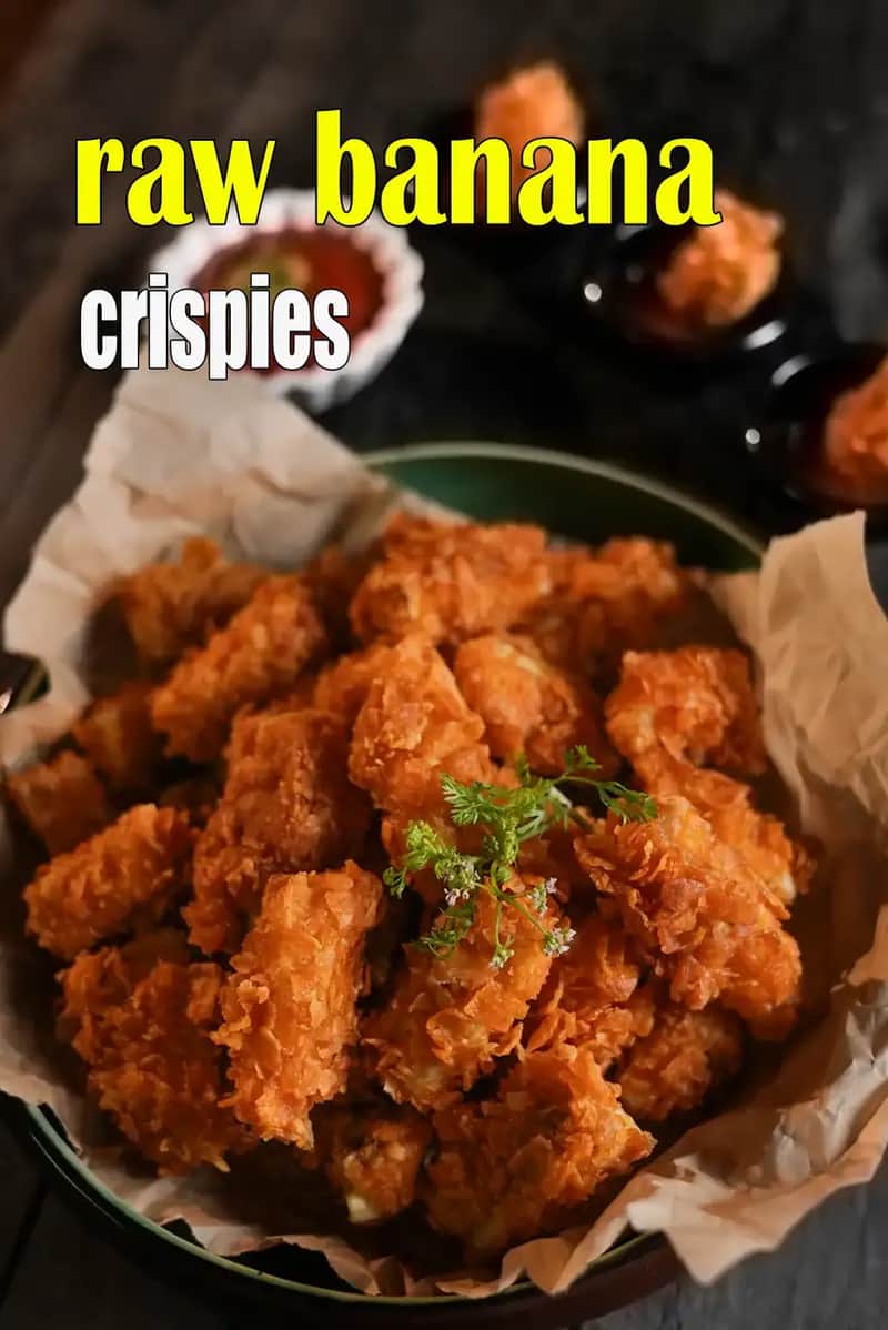 Raw banana crispies made from battered and deep-fried raw banana pieces, golden and crunchy, served in a bowl with chutney on the side.