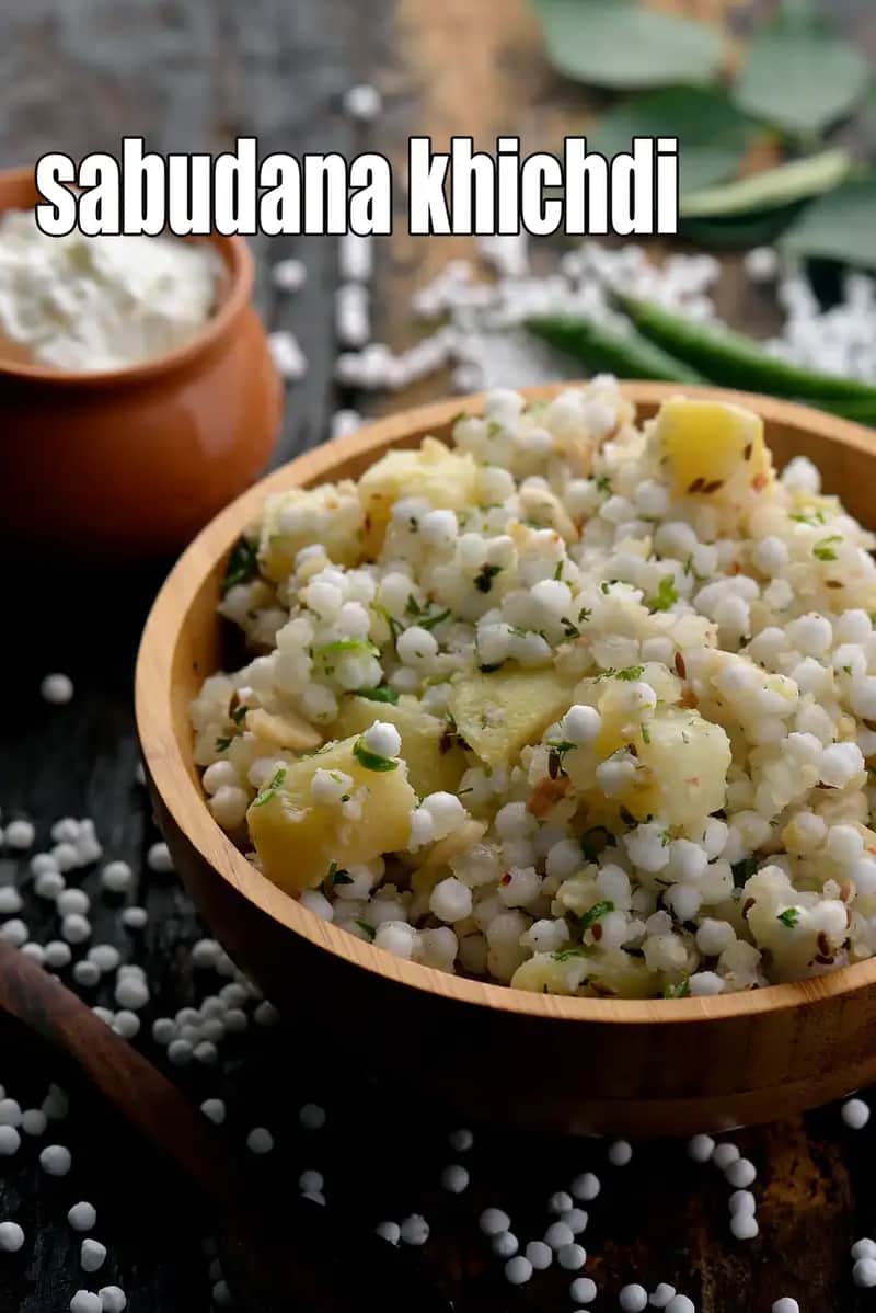 A wooden bowl of Sabudana Khichdi garnished with fresh coriander and peanuts, served with a side of curd.